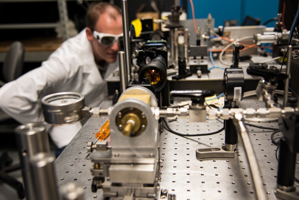 AFRL/RW scientist works on an experiment in a photonics laboratory