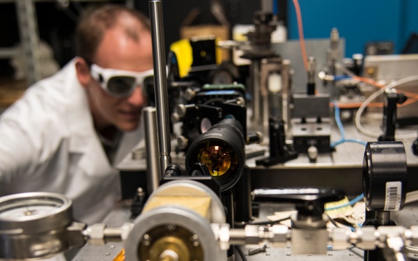 AFRL/RW scientist works on an experiment in a photonics laboratory