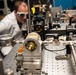 AFRL/RW scientist works on an experiment in a photonics laboratory