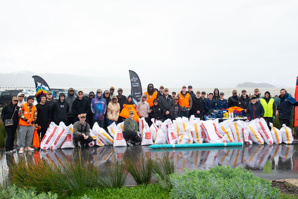 Blue Ridge Sailors clean a beach with the New Zealand Defence Force