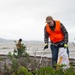 Blue Ridge Sailors clean a beach with the New Zealand Defence Force