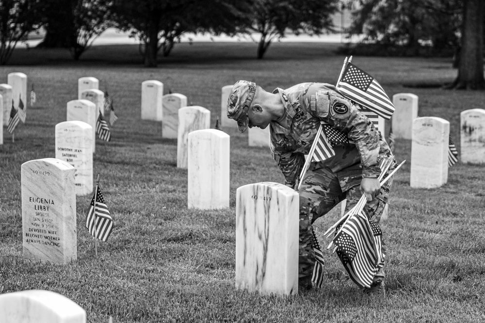 U.S. Army Soldiers assigned to the 3d U.S. Infantry Regiment (The Old Guard), participate in Flags In at Arlington National Cemetery
