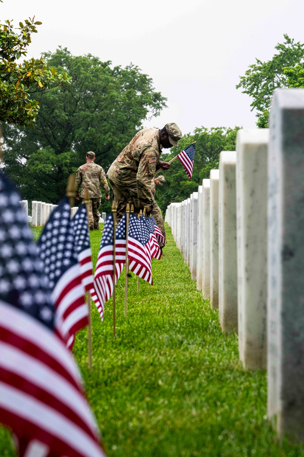 U.S. Army Soldiers assigned to the 3d U.S. Infantry Regiment (The Old Guard), participate in Flags In at Arlington National Cemetery
