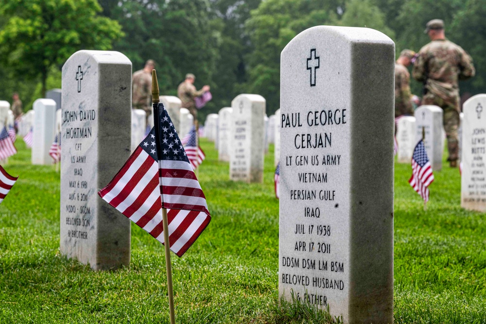 U.S. Army Soldiers assigned to the 3d U.S. Infantry Regiment (The Old Guard), participate in Flags In at Arlington National Cemetery