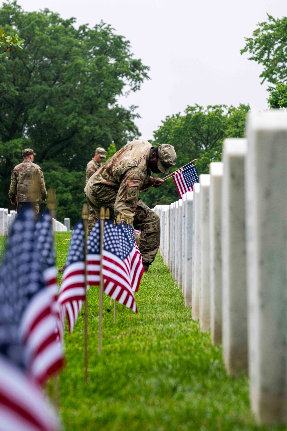 U.S. Army Soldiers assigned to the 3d U.S. Infantry Regiment (The Old Guard), participate in Flags In at Arlington National Cemetery