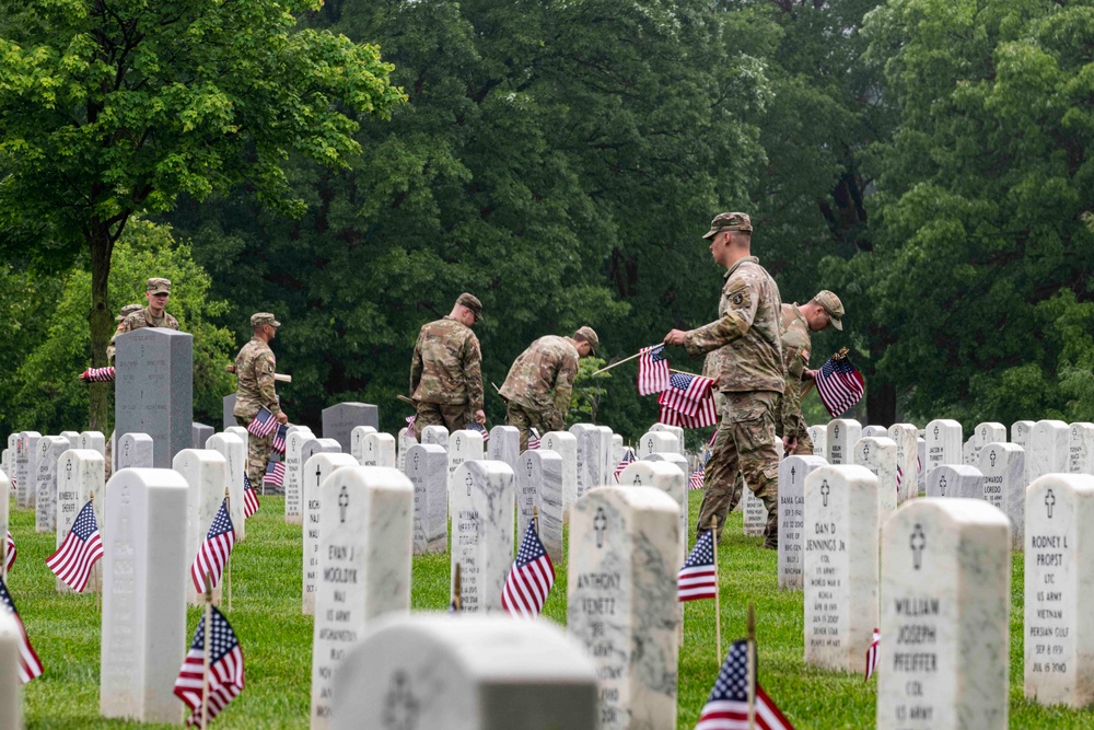 U.S. Army Soldiers assigned to the 3d U.S. Infantry Regiment (The Old Guard), participate in Flags In at Arlington National Cemetery
