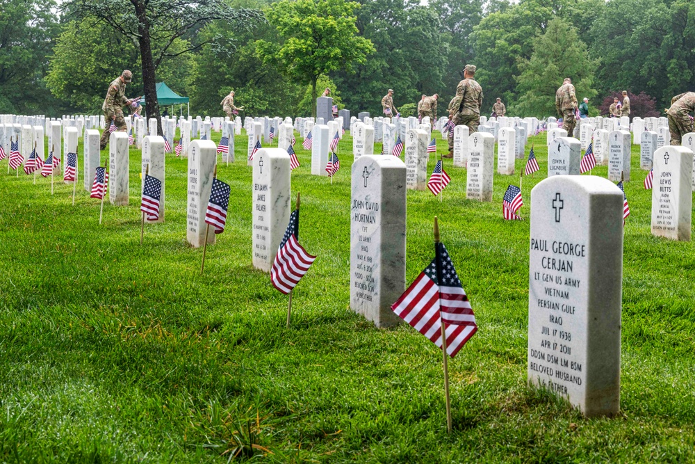 U.S. Army Soldiers assigned to the 3d U.S. Infantry Regiment (The Old Guard), participate in Flags In at Arlington National Cemetery