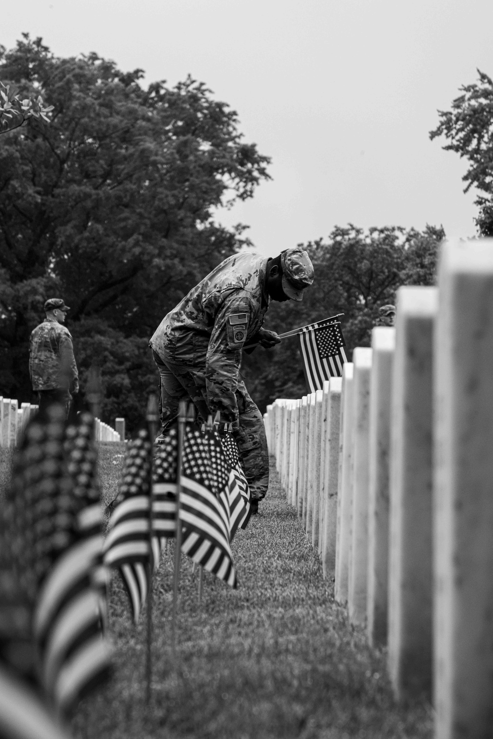 U.S. Army Soldiers assigned to the 3d U.S. Infantry Regiment (The Old Guard), participate in Flags In at Arlington National Cemetery.