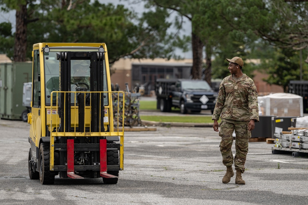 23 LRS Deployment and Distribution Team offloads deployment cargo