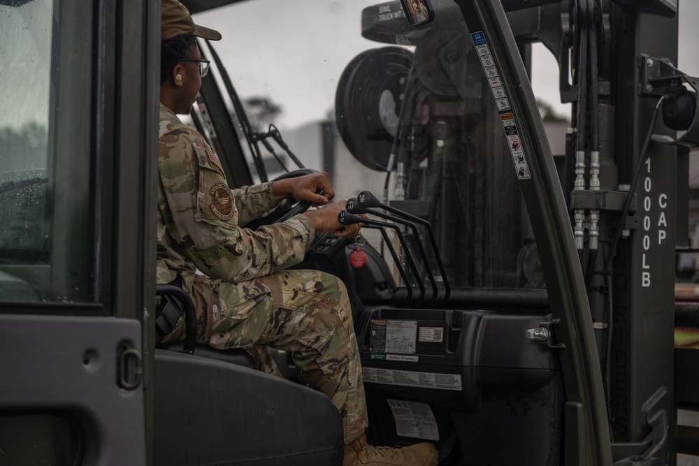 23 LRS Deployment and Distribution Team offloads deployment cargo