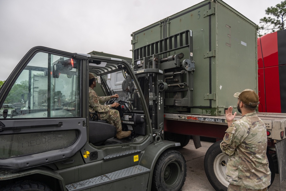 23 LRS Deployment and Distribution Team offloads deployment cargo