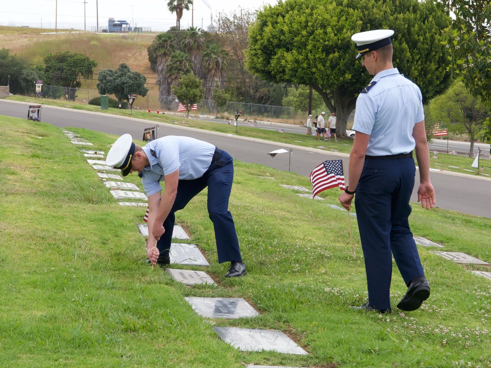 U.S. Coast Guard Academy cadets, from New London, Connecticut, place an American flag on a grave of a World War II veteran at Green Hills Memorial Park in Rancho Palos Verdes, California, May 24, 2025.