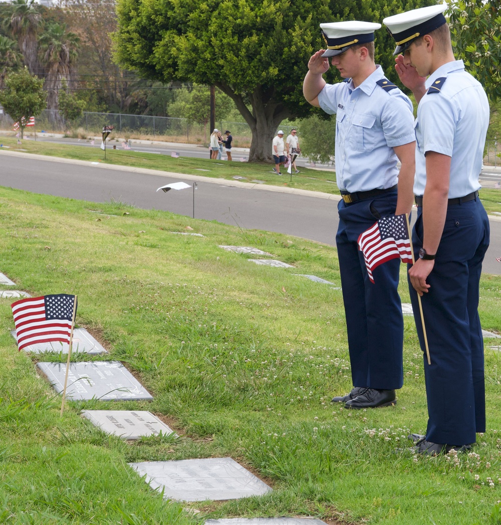 U.S. Coast Guard Academy cadets, from New London, Connecticut, salute a grave of a World War II veteran during a flag placing ceremony at Green Hills Memorial Park in Rancho Palos Verdes, California, May 24, 2025.