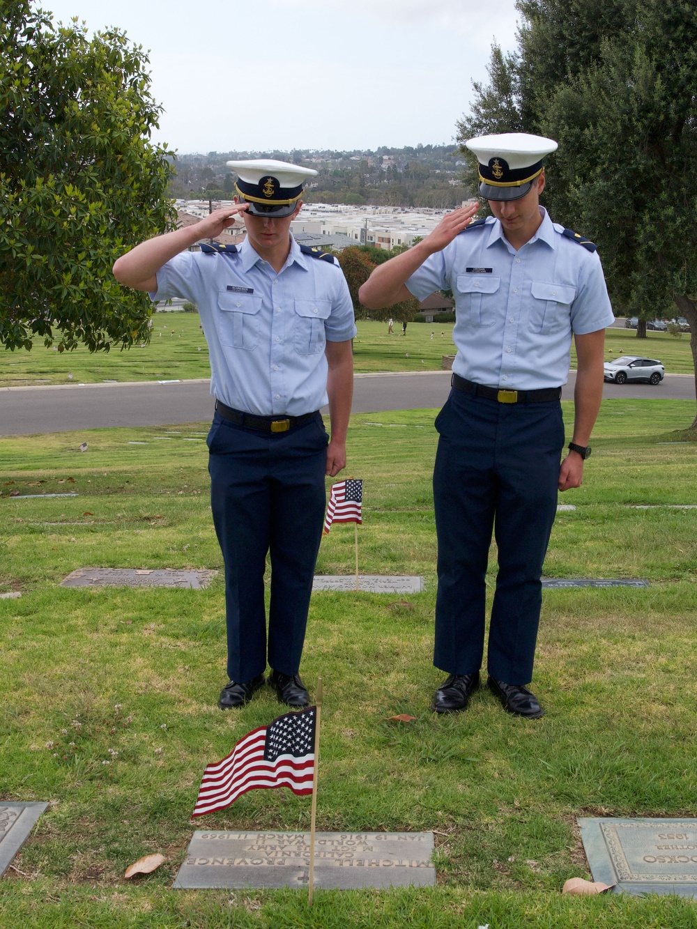 U.S. Coast Guard Academy cadets, from New London, Connecticut, salute a grave of a World War II veteran during a flag placing ceremony at Green Hills Memorial Park in Rancho Palos Verdes, California, May 24, 2025.