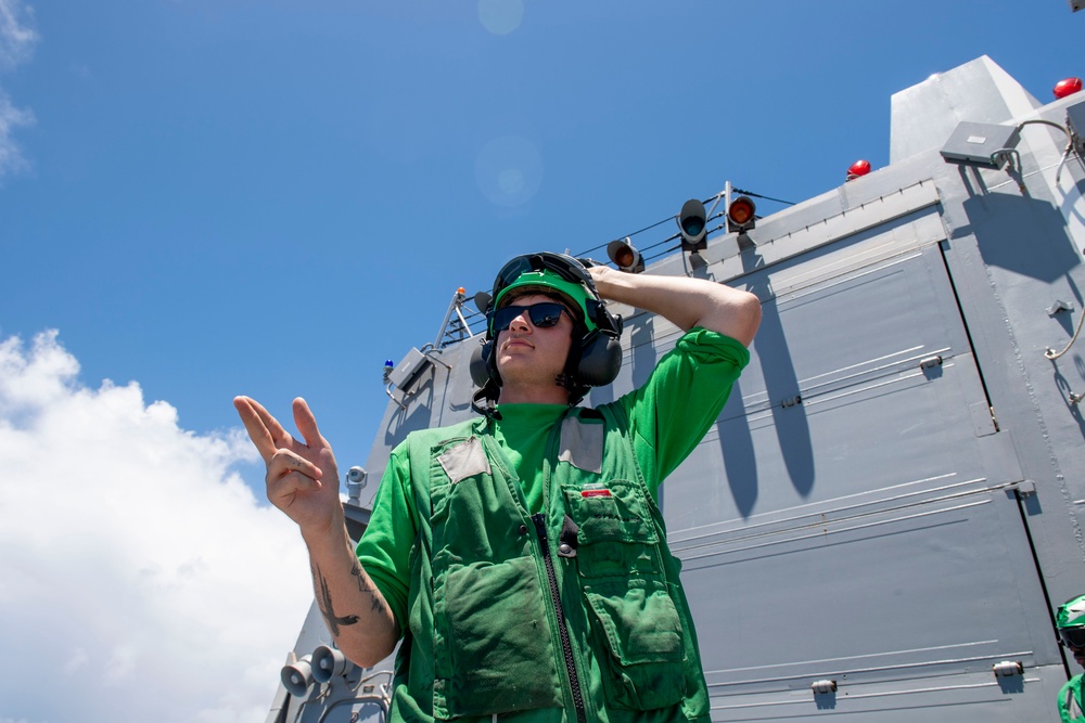 Sailor Signals Helicopter During Flight Quarters