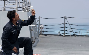 Sailor Inspects Equipment