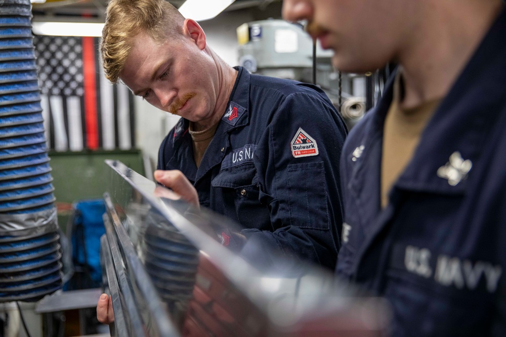 USS Preble Sailor Repairs Equipment