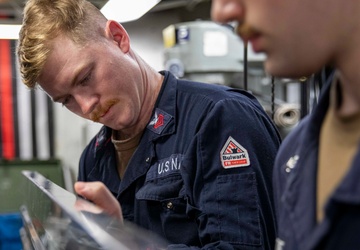 USS Preble Sailor Repairs Equipment