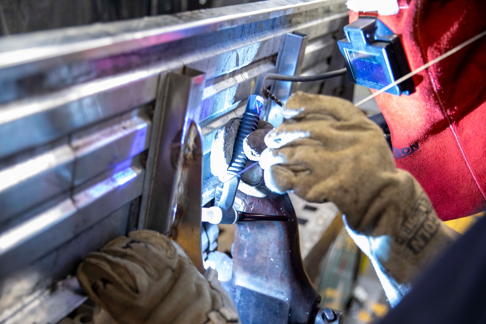 USS Preble Sailor Repairs Equipment