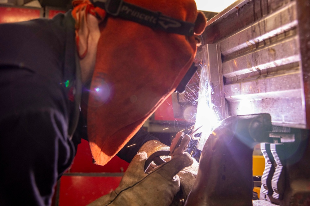 USS Preble Sailor Repairs Equipment