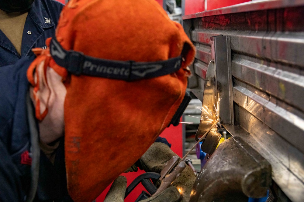 USS Preble Sailor Repairs Equipment