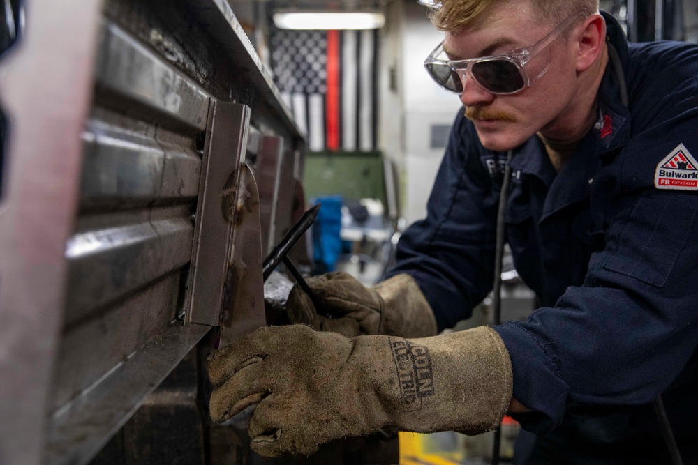 USS Preble Sailor Repairs Equipment
