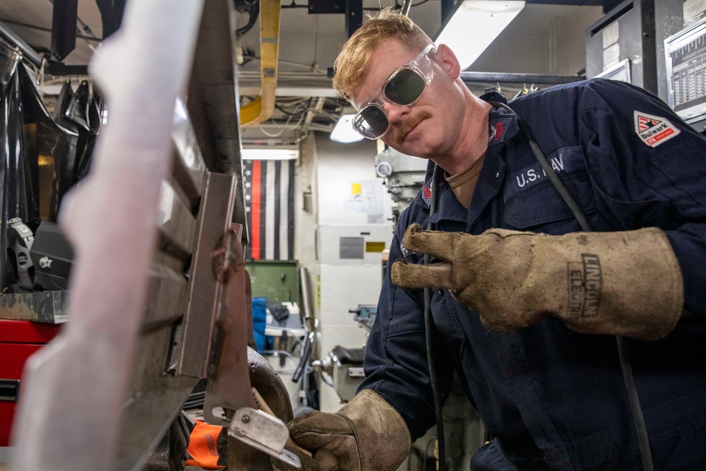 USS Preble Sailor Repairs Equipment