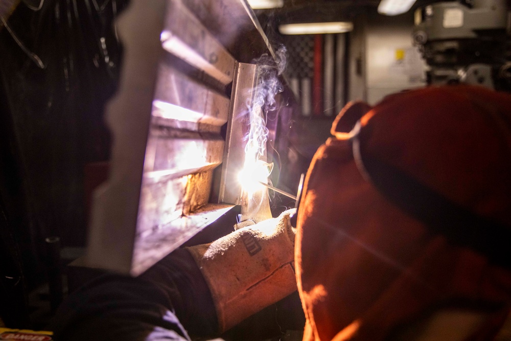 USS Preble Sailor Repairs Equipment