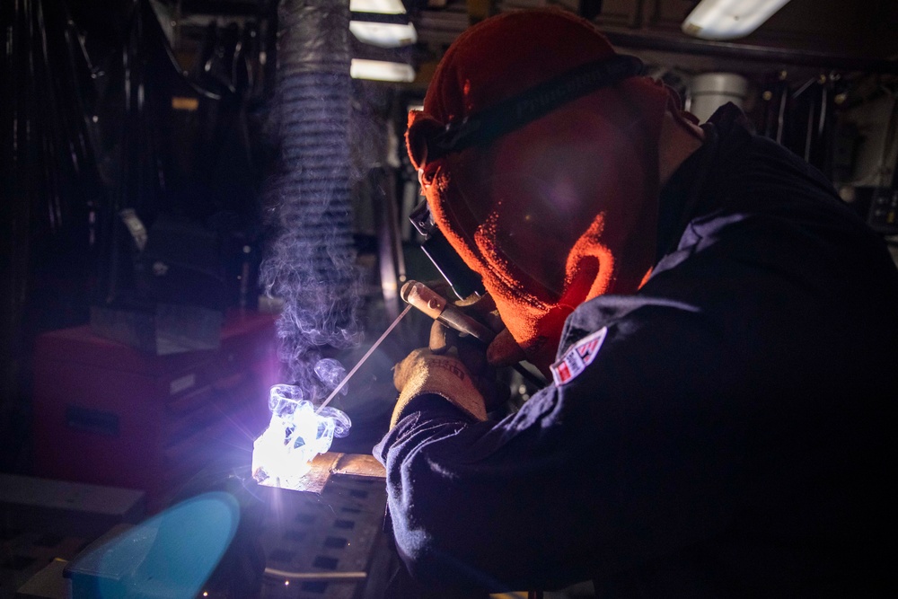 USS Preble Sailor Repairs Equipment