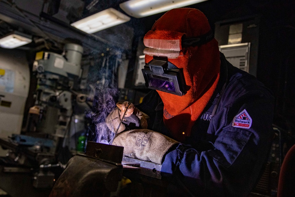 USS Preble Sailor Repairs Equipment