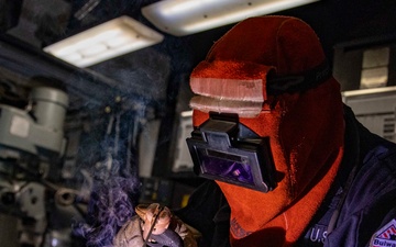 USS Preble Sailor Repairs Equipment