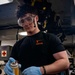 Nimitz Sailor Applies Cleaning Solution to Bomb Rack Components