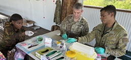 Service members make blood smears as part of the disease surveillance efforts at No Sick Soljia 2025 in Wewak, Papua New Guinea.