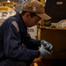 Sailor conducts maintenance on forklift