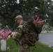 A Soldier from the 3d U.S. Infantry Regiment (The Old Guard) places American flags at headstones during “Flags In” at Arlington National Cemetery, Arlington, Va., May 22, 2025.
