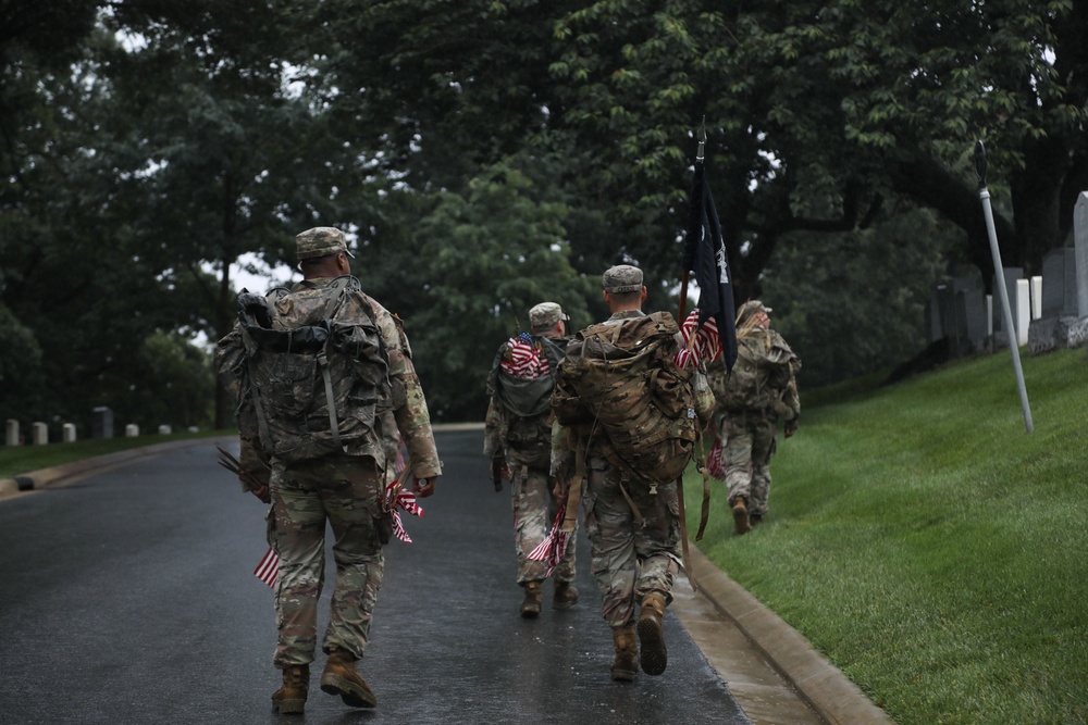 Soldiers from the 3d U.S. Infantry Regiment (The Old Guard) carry American flags to place at headstones as part of “Flags In” at Arlington National Cemetery, Arlington, Va., May 22, 2025.
