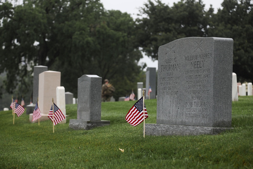 American flags are placed at headstones as part of “Flags In” in Arlington National Cemetery, Arlington, Va., May 22, 2025.