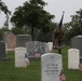 A Soldier from the 3d U.S. Infantry Regiment (The Old Guard) finishes placing American flags at headstones as part of “Flags In” in Arlington National Cemetery, Arlington, Va., May 22, 2025.