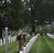A Soldier from the 3d U.S. Infantry Regiment (The Old Guard) places American flags at headstones as part of &quot;Flags In&quot; at Arlington National Cemetery, Arlington, Va., May 22, 2025.