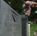 A Soldier from the 3d U.S. Infantry Regiment (The Old Guard) places American flags at headstones as part of &quot;Flags In&quot; at Arlington National Cemetery, Arlington, Va., May 22, 2025.