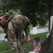 A Soldier from the 3d U.S. Infantry Regiment (The Old Guard) places American flags at headstones as part of &quot;Flags In&quot; at Arlington National Cemetery, Arlington, Va., May 22, 2025.