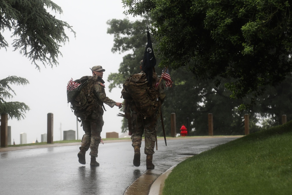 Soldiers from the 3d U.S. Infantry Regiment (The Old Guard) walk their assigned cemetery section to place American flags at headstones during &quot;Flags In&quot; at Arlington National Cemetery, Arlington, Va., May 22, 2025.
