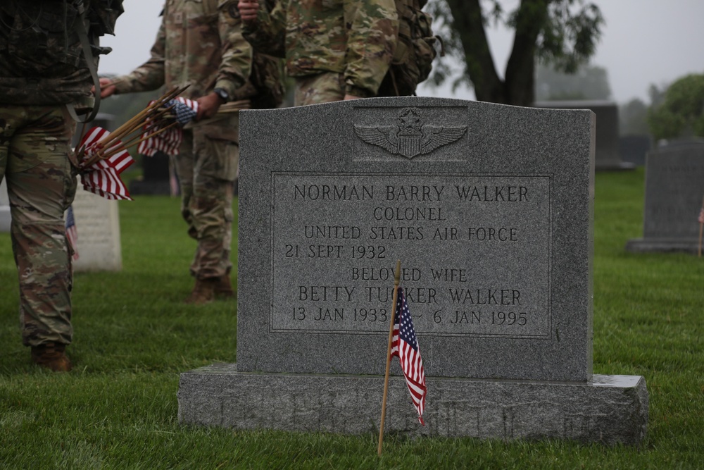 Soldiers from the 3d U.S. Infantry Regiment (The Old Guard) places American flags at headstones as part of &quot;Flags In&quot; at Arlington National Cemetery, Arlington, Va., May 22, 2025.