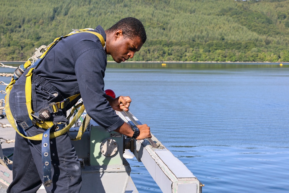 Cryptologic Technician (Technical) 2nd Class Darren Grant prepares surfaces for preservation