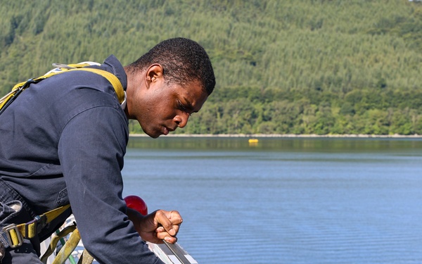 Cryptologic Technician (Technical) 2nd Class Darren Grant prepares surfaces for preservation