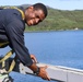 Cryptologic Technician (Technical) 2nd Class Darren Grant prepares surfaces for preservation and painting