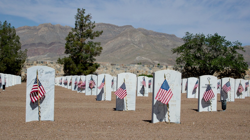 Flags placed at Fort Bliss National Cemetery before Memorial Day