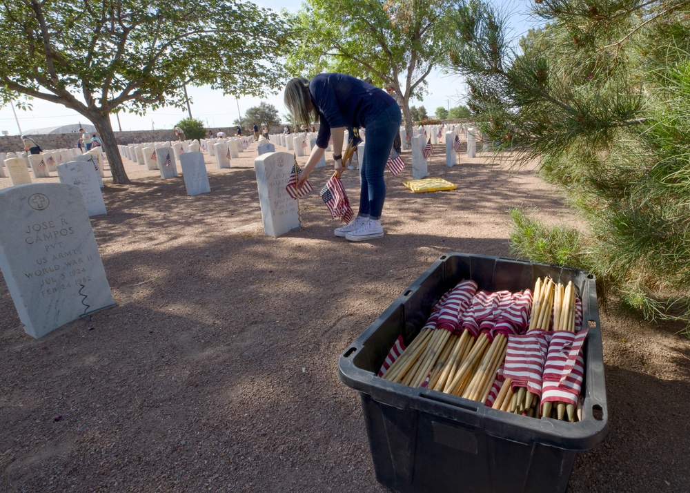 Flags placed at Fort Bliss National Cemetery before Memorial Day