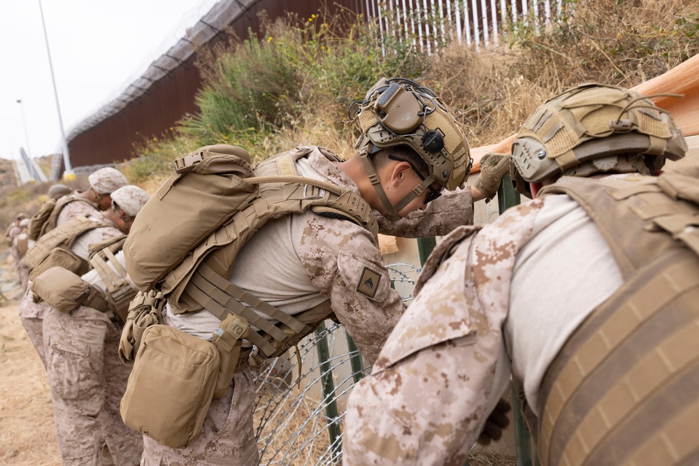 U.S. Marines with Task Force Sapper adjust concertina wire
