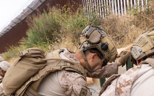 U.S. Marines with Task Force Sapper adjust concertina wire